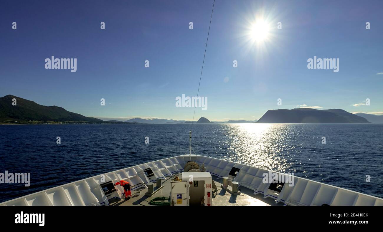 Ship workers on the top of the Polarlys, cruise ship, mountains, rocks, water, sky, Godøya, Møre og Romsdal, Norway, Scandinavia, Europe Stock Photo