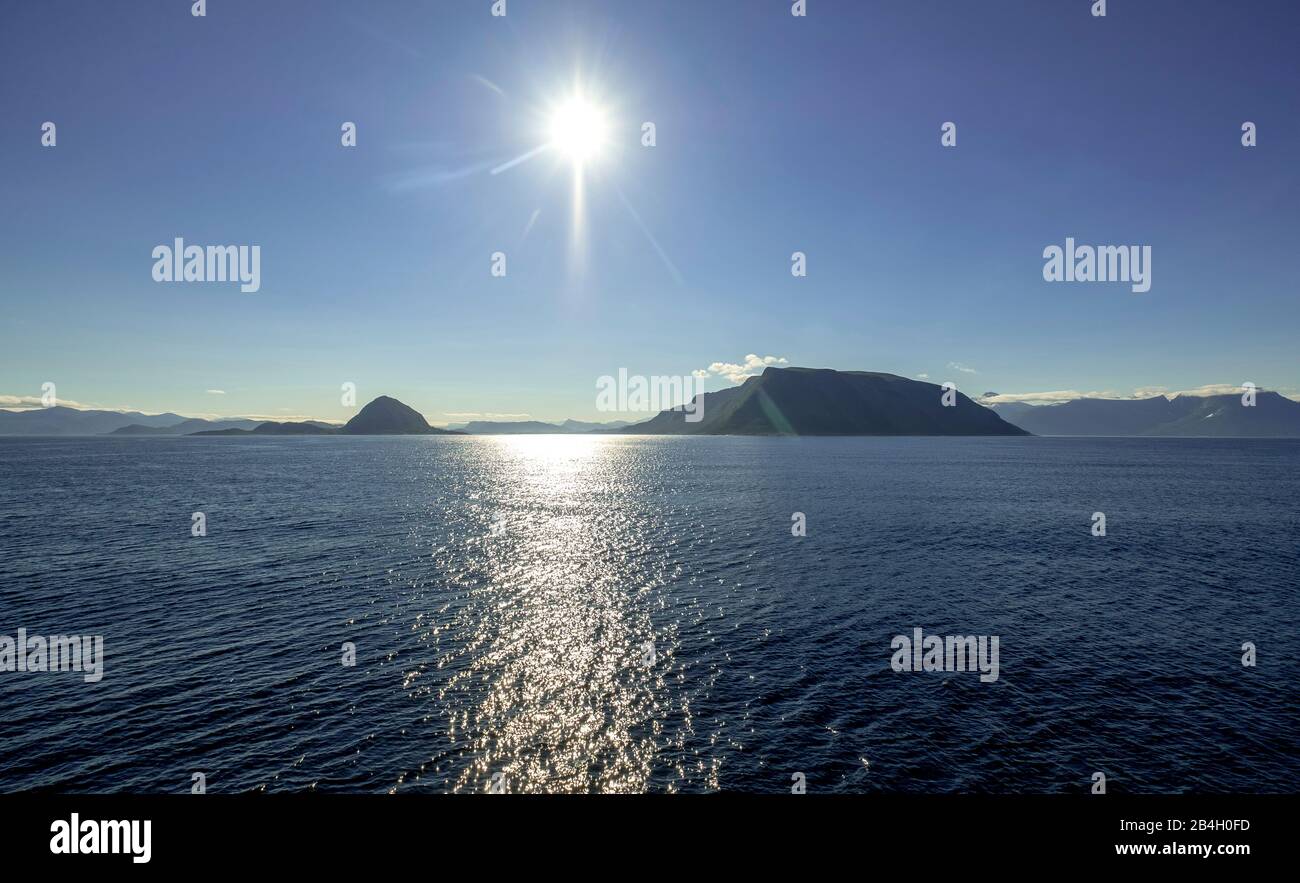 Crags stick out of the sea, sunshine, blue sky, shining sea water, Godøya, Møre og Romsdal, Norway, Scandinavia, Europe Stock Photo