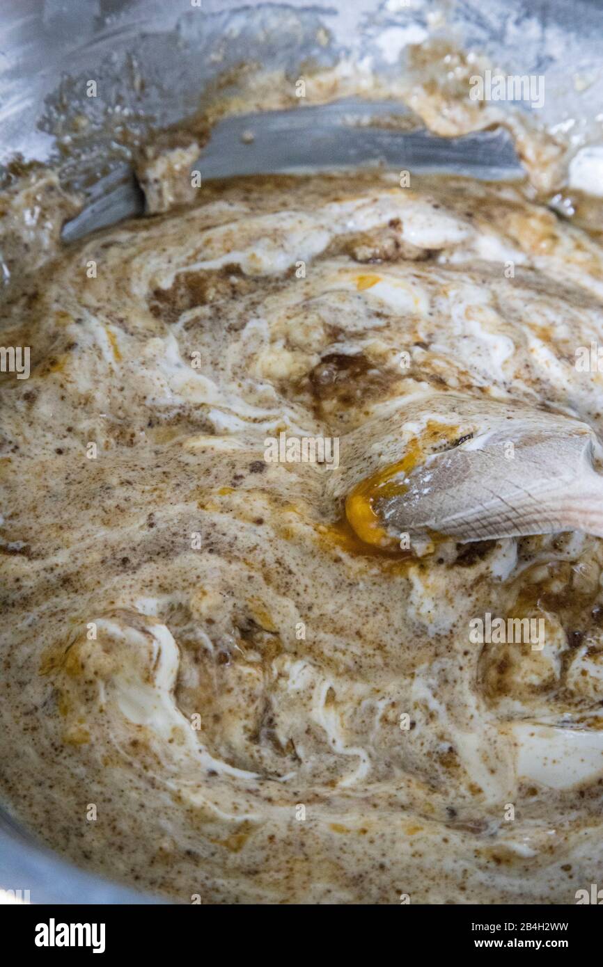 Cake dough in shots and wooden spoon Stock Photo