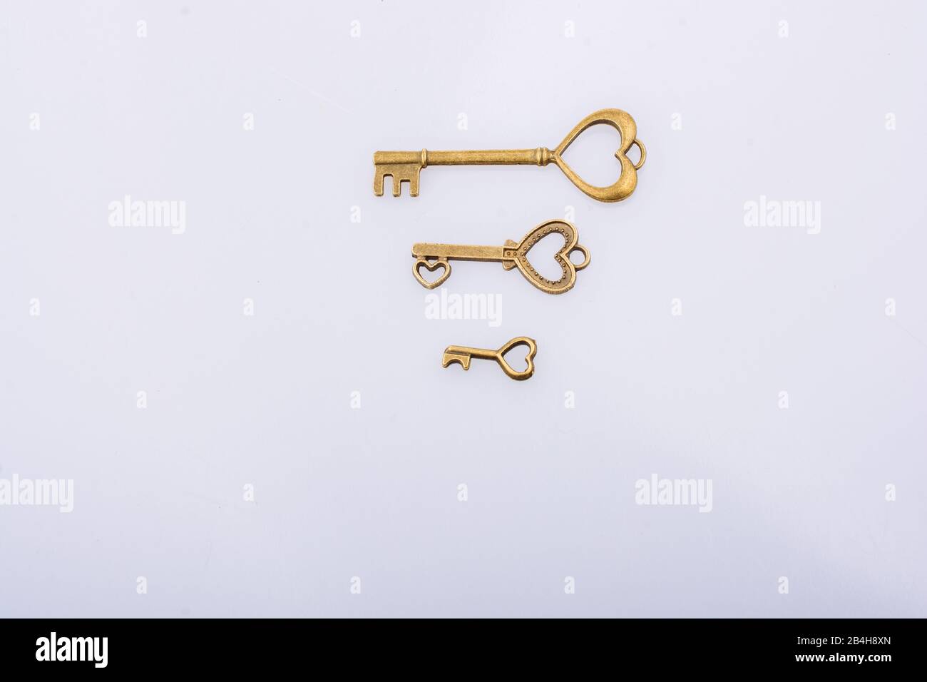Heart shaped retro metal keys on white background Stock Photo - Alamy