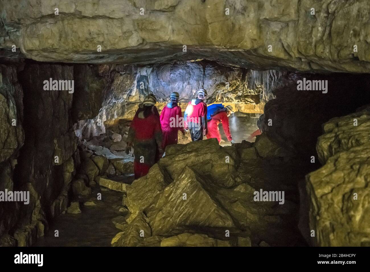 Germany, Baden-Württemberg, Bad Urach, cavers explore the Falkensteiner cave. It is a so-called 'wild cave', not a show cave, and is only accessible to tourists for a short while. In the novel 'Rulaman' by David Friedrich Weinland she is the Huhkahöhle. Stock Photo