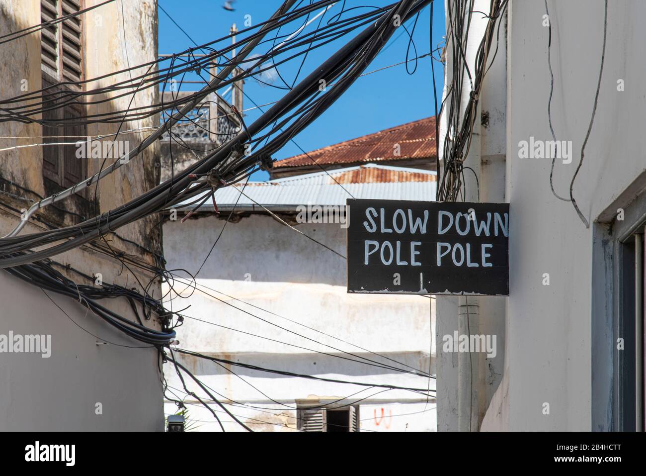 Destination Tanzania, Zanzibar Island: Impressions from Stone Town. "Pole pole" slow down signs in the streets. Stock Photo