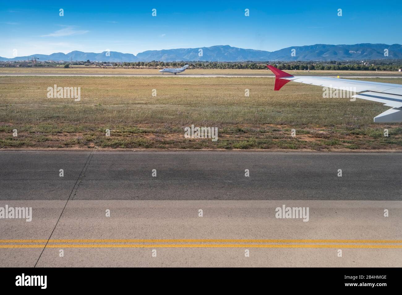 View from the window of an airplane on the runway of Palma de Mallorca with mountain range, charter plane Stock Photo