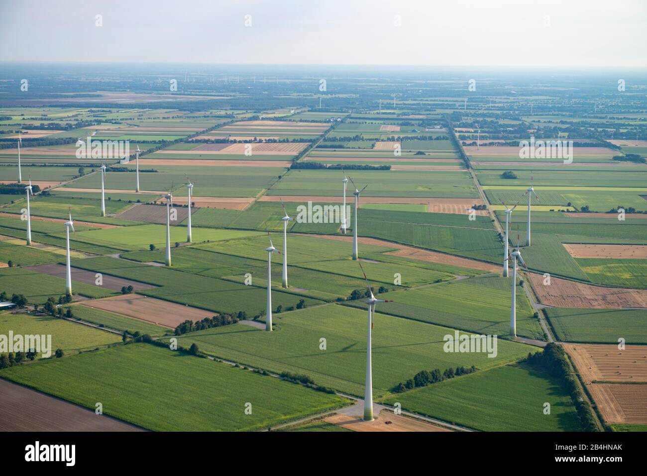 Aerial view of a landscape of agricultural fields and wind turbines ...