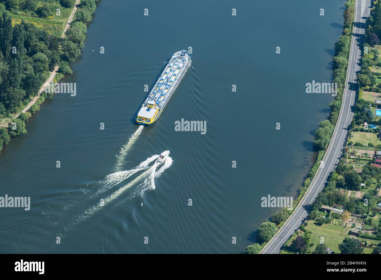 Aerial view of a cargo ship and a speedboat on the Rhine Stock Photo