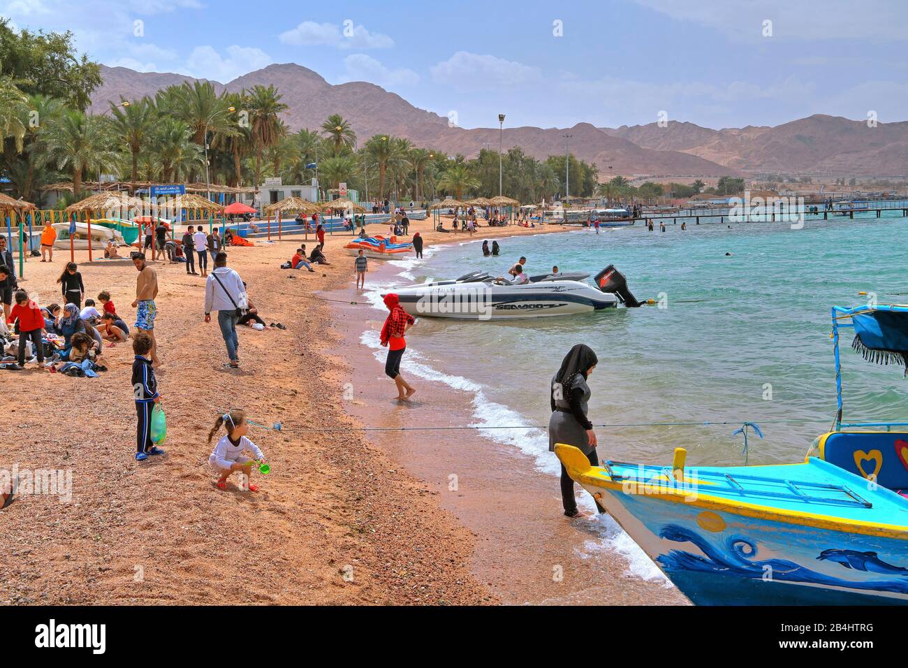 Locals at the city beach Aqaba Aqaba, Gulf of Aqaba, Red Sea, Jordan Stock Photo