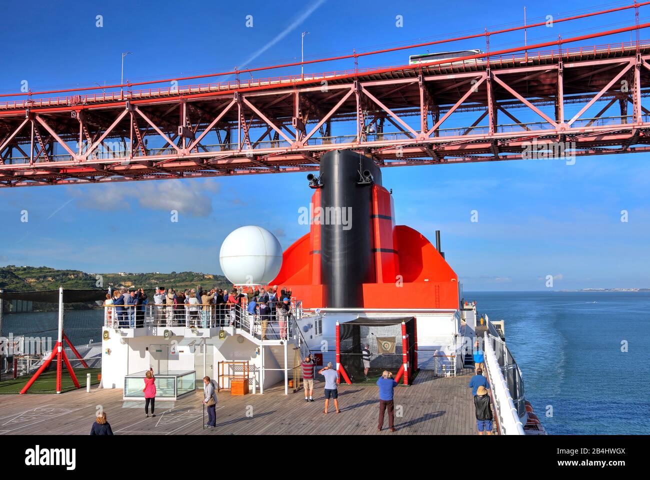Upper decks with chimney of transatlantic liner Queen Mary 2 under the tea press bridge, Lisbon, Portugal Stock Photo