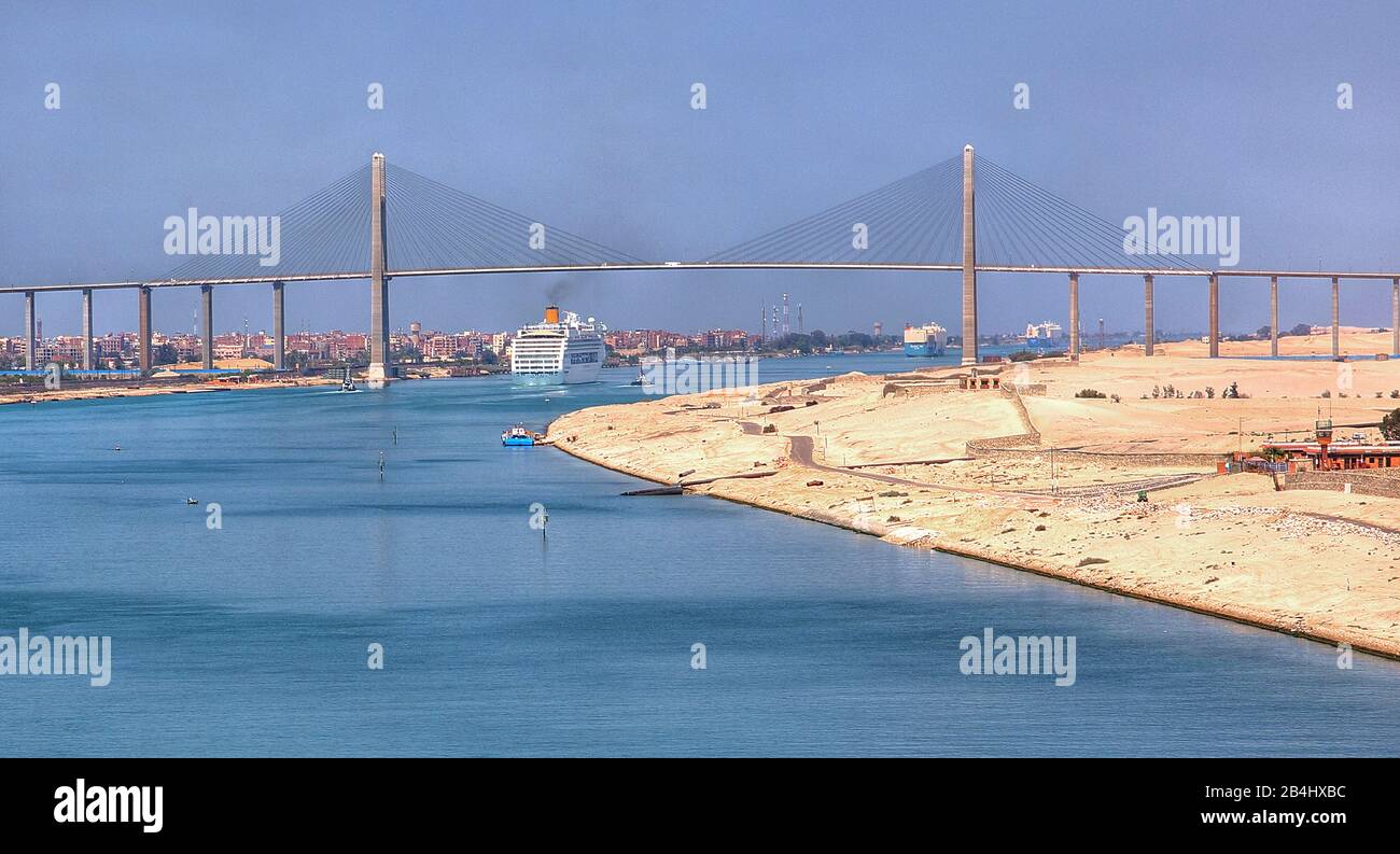 Cruise ship Costa Victoria under the Suez Canal bridge near Port Said in the Suez Canal, Egypt Stock Photo