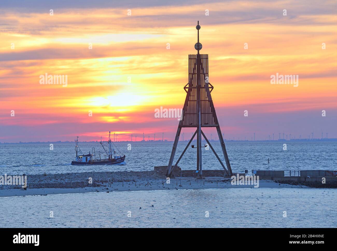 Seezeichen Kugelbake at the Elbe estuary in the district Döse with trawler at sunrise, North Sea resort Cuxhaven, Elbe estuary, North Sea, North Sea coast, Lower Saxony, Germany Stock Photo