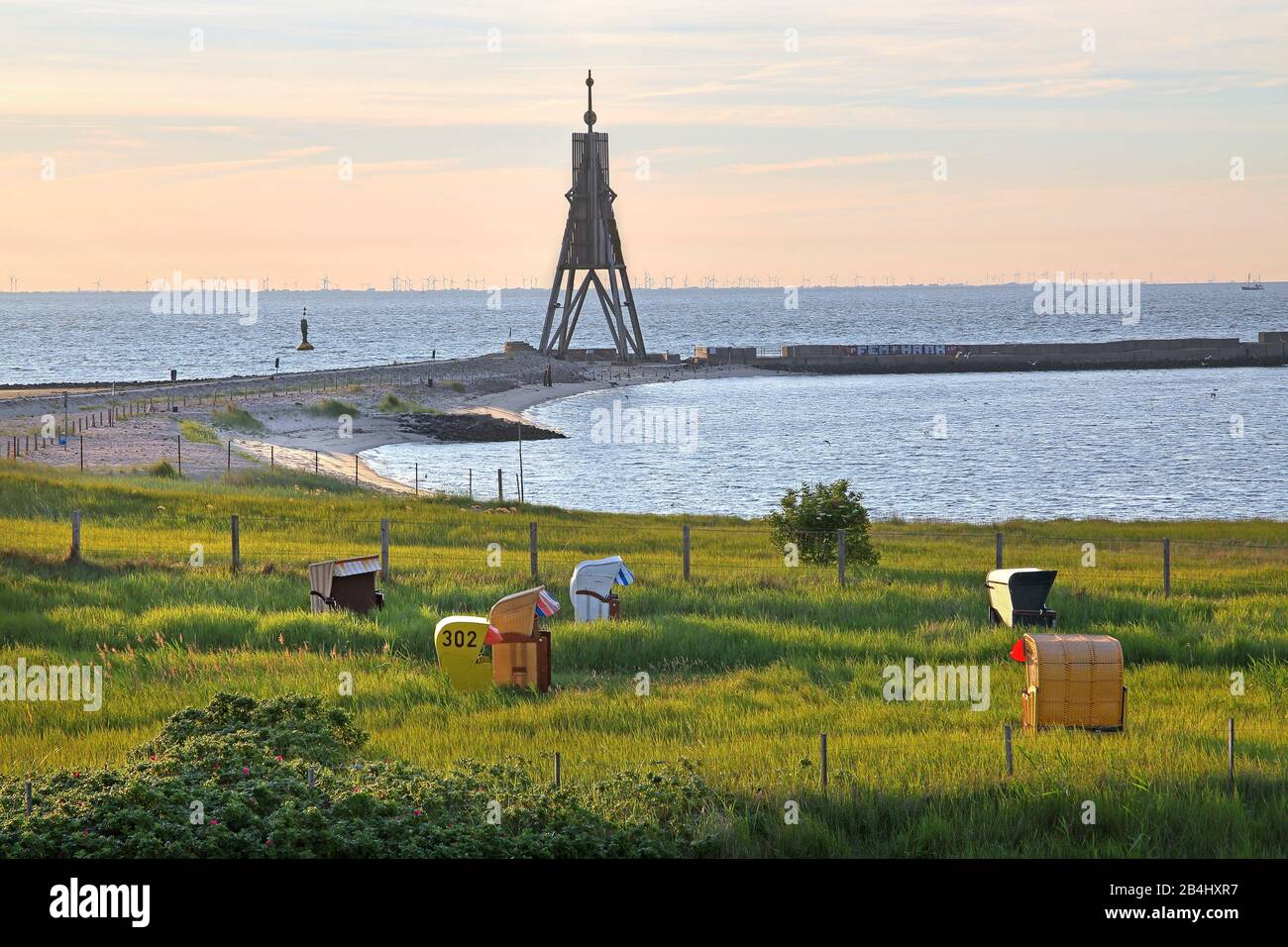 Grass beach with beach chairs and sea sign Kugelbake at the Elbe estuary in the district Döse at early morning sun, North Sea resort Cuxhaven, Elbe estuary, North Sea, North Sea coast, Lower Saxony, Germany Stock Photo