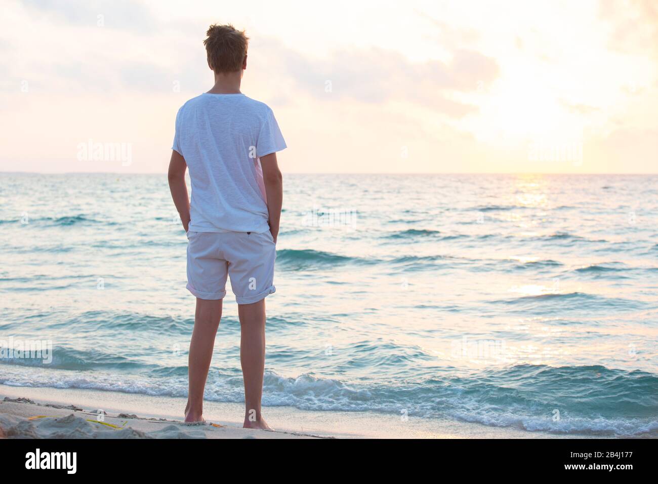 Boy, standing, from behind, sea Stock Photo Alamy