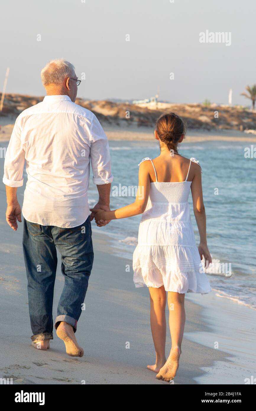Grandpa, granddaughter, stand, walk, from behind Stock Photo
