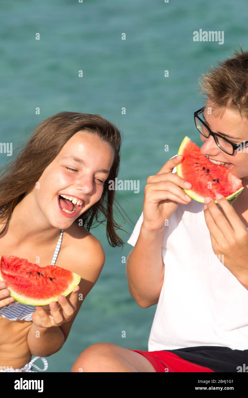 Watermelon, siblings, sea, laugh Stock Photo