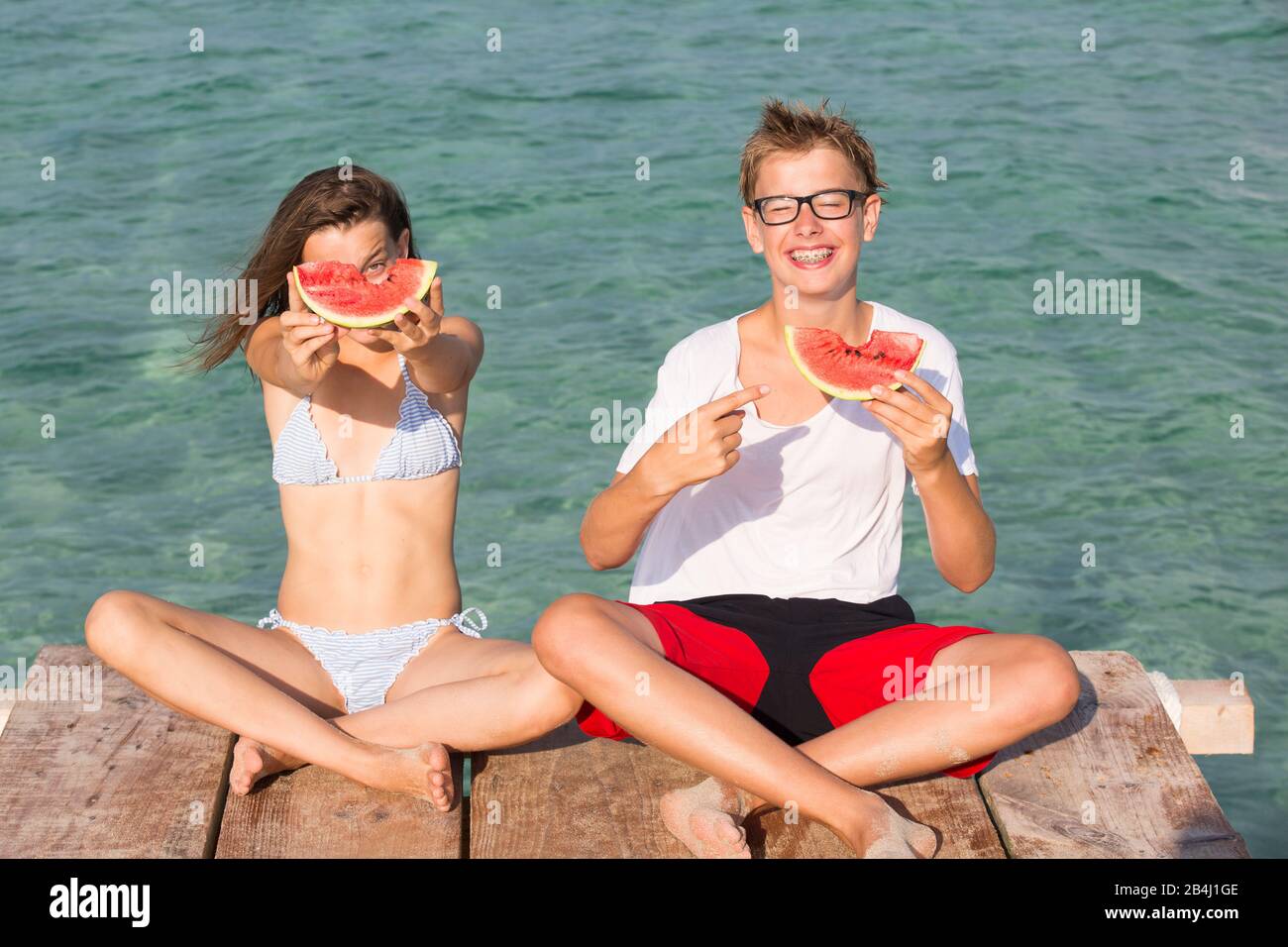 Siblings, watermelon, smile, footbridge Stock Photo