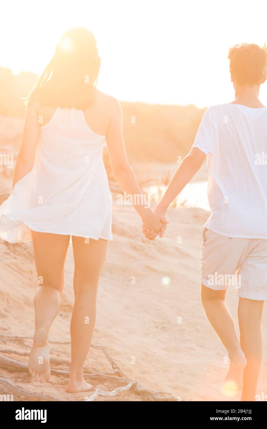 Siblings, holding hands, back light Stock Photo