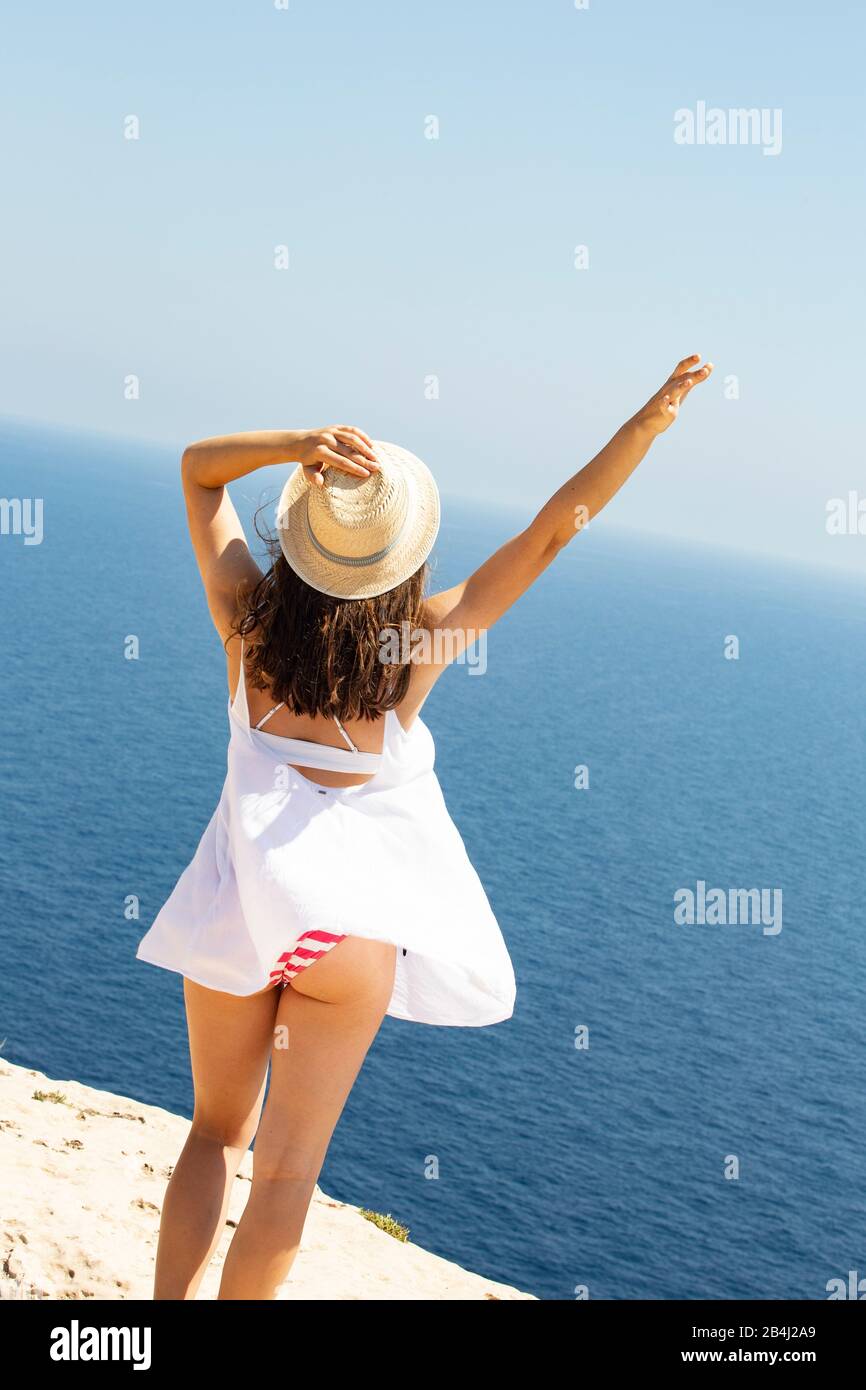 Joy, teenagers, hat, sea, from behind Stock Photo
