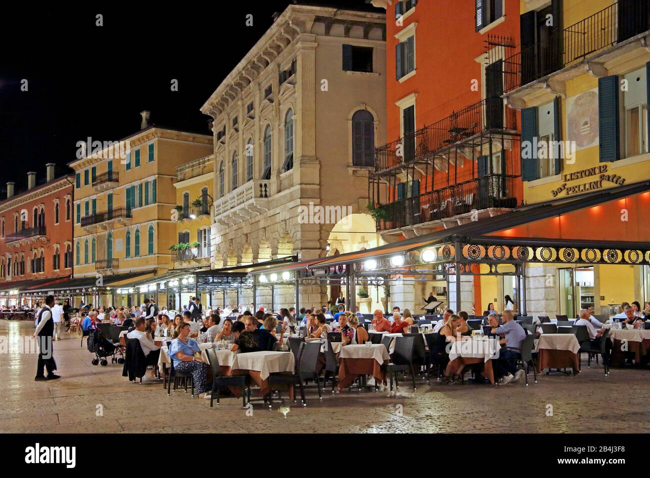 Palazzi in Piazza Bra with restaurant terraces at night, old town, Verona, Veneto, Italy Stock Photo