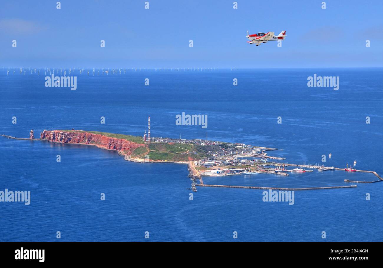 Sport airplane over island of southwest with the cliff and south harbor, Helgoland, Helgoland bay, German Bight, North Sea island, North Sea, Schleswig-Holstein, Germany Stock Photo