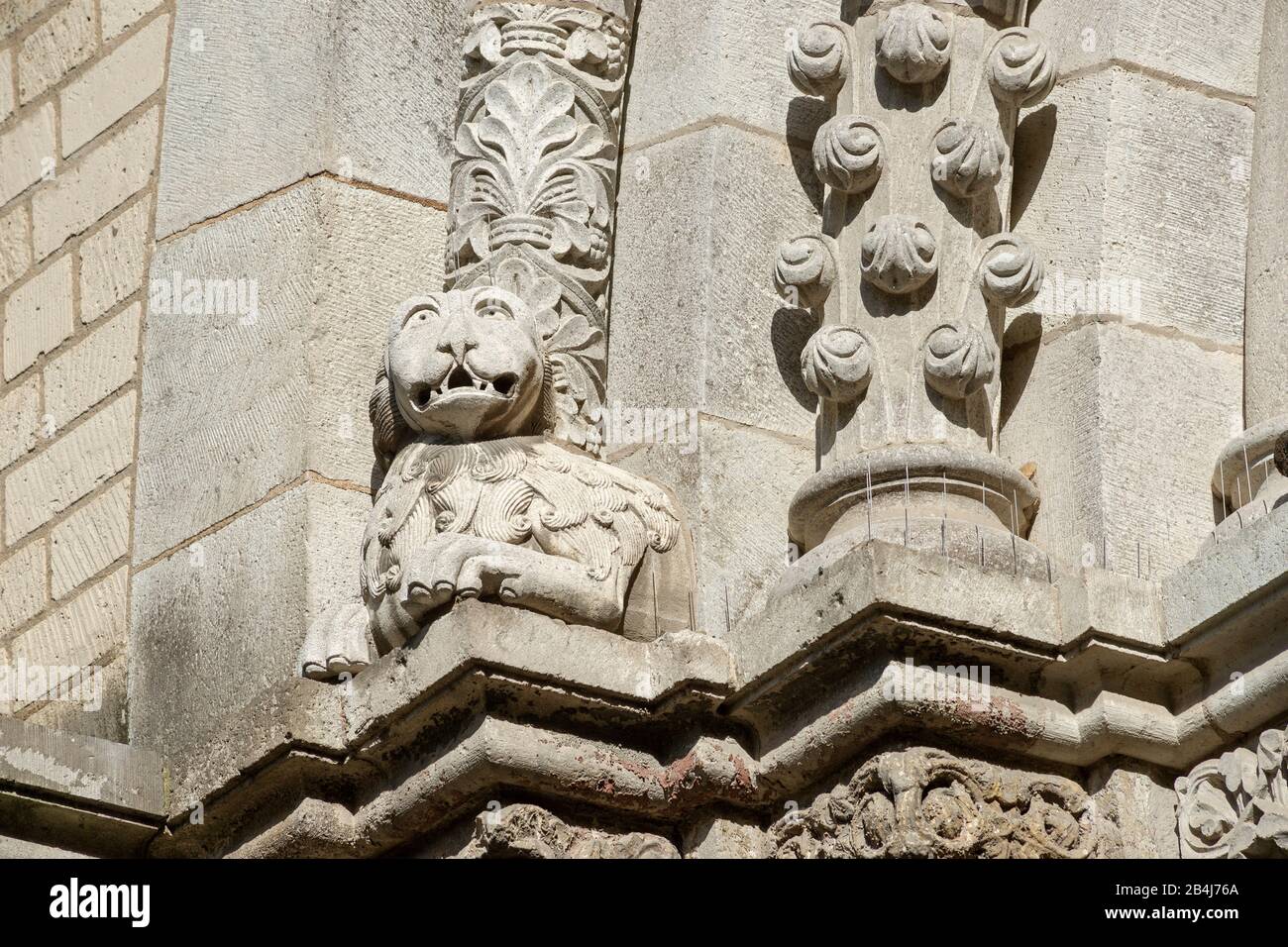 Germany, North Rhine-Westphalia, Cologne, lion at the base of the west portal arch of the church Groß St. Martin. The church is one of the twelve major Romanesque churches in the center of Cologne. It has a Vierungsturm with 4 corner turrets and is the landmark of the left bank of the city panorama. Stock Photo