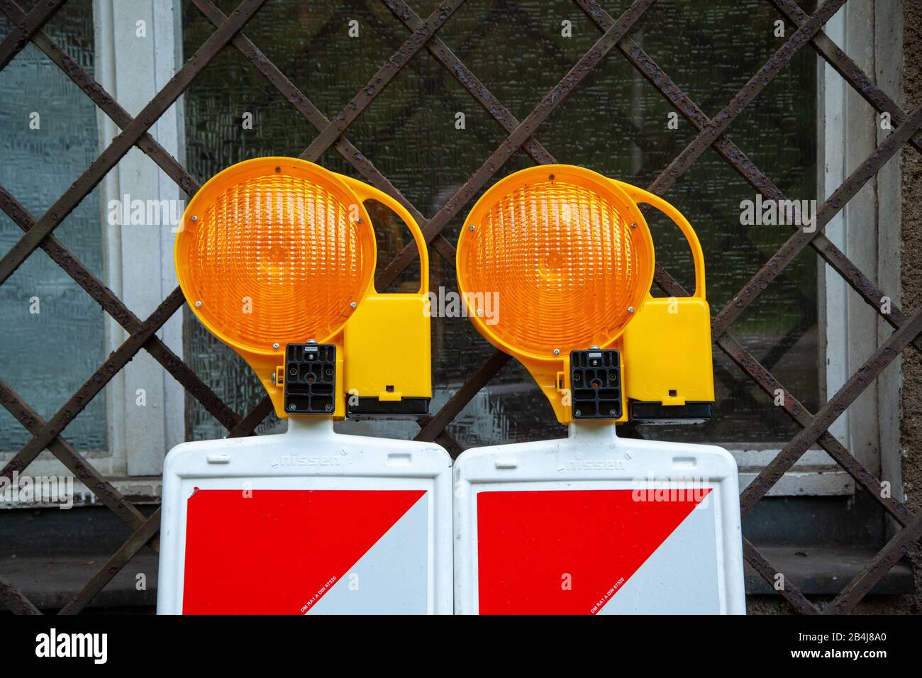 Leipzig, Germany, 04-14-2016 Two traffic beacons with signal lights are leaning against a window Stock Photo
