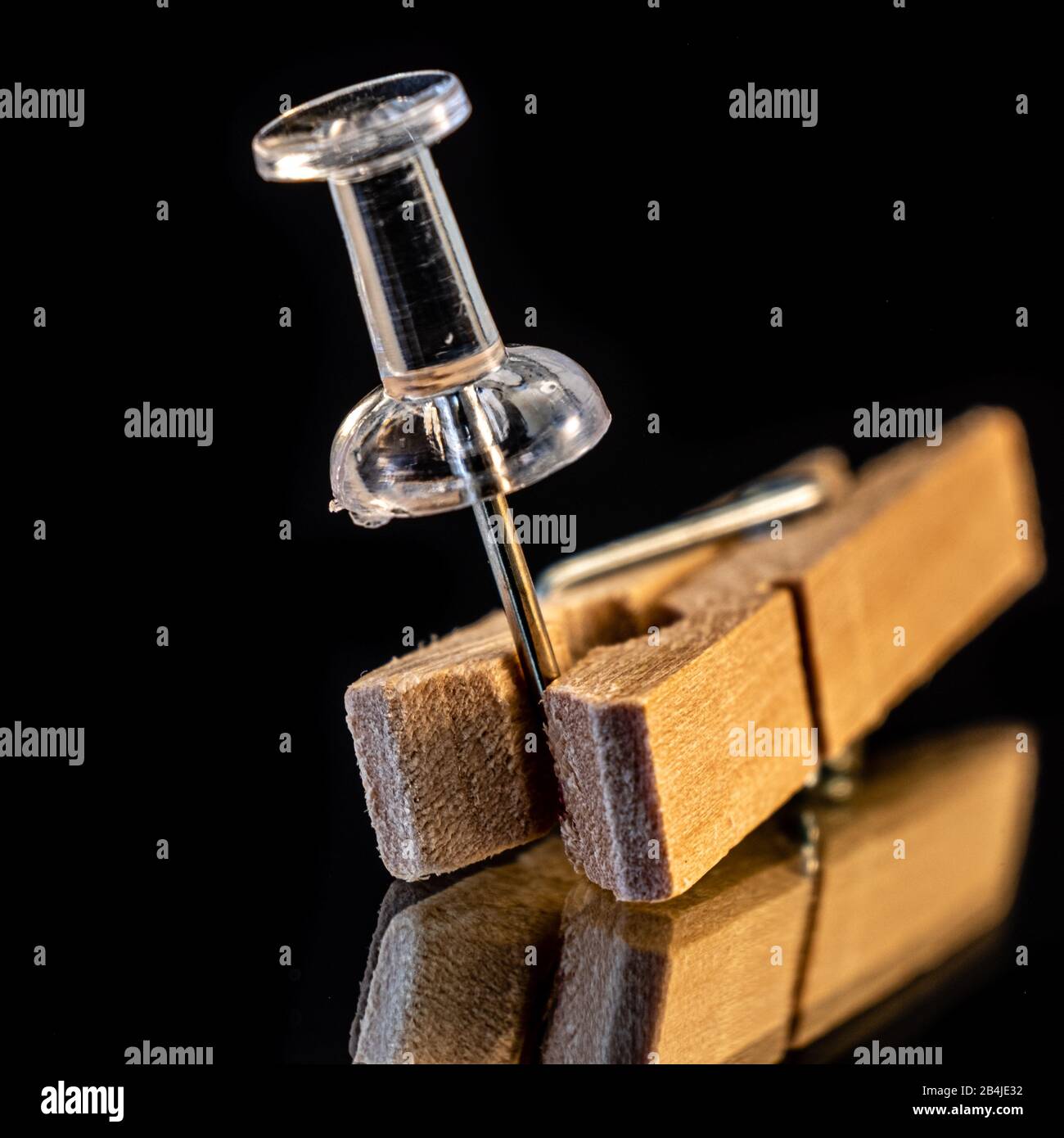 A clothespin holding a push pin Stock Photo Alamy
