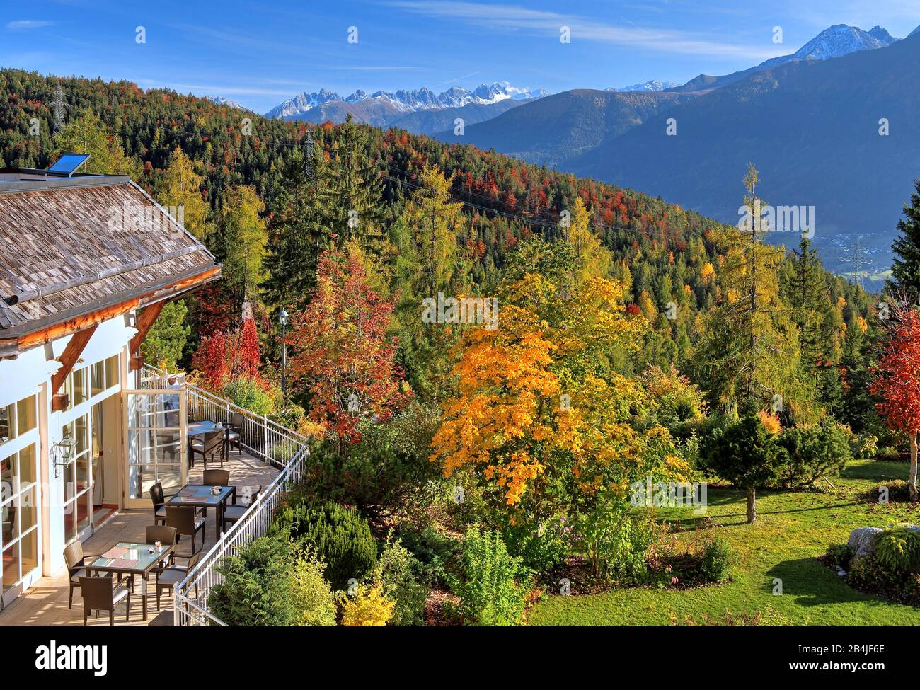 Restaurant terrace and garden of the Interalpenhotel with a view of the Inn Valley and the Kalkkögel (2804m), Telfs, Tyrol, Austria Stock Photo