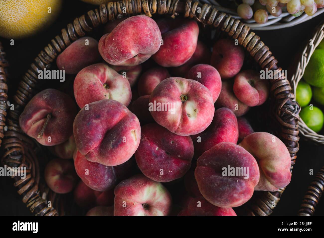 flat Peaches in basket for sale, closeup Stock Photo Alamy