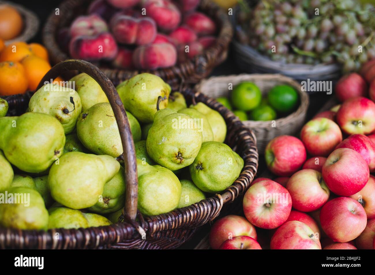 Various types of fruit in baskets for sale hires stock photography and
