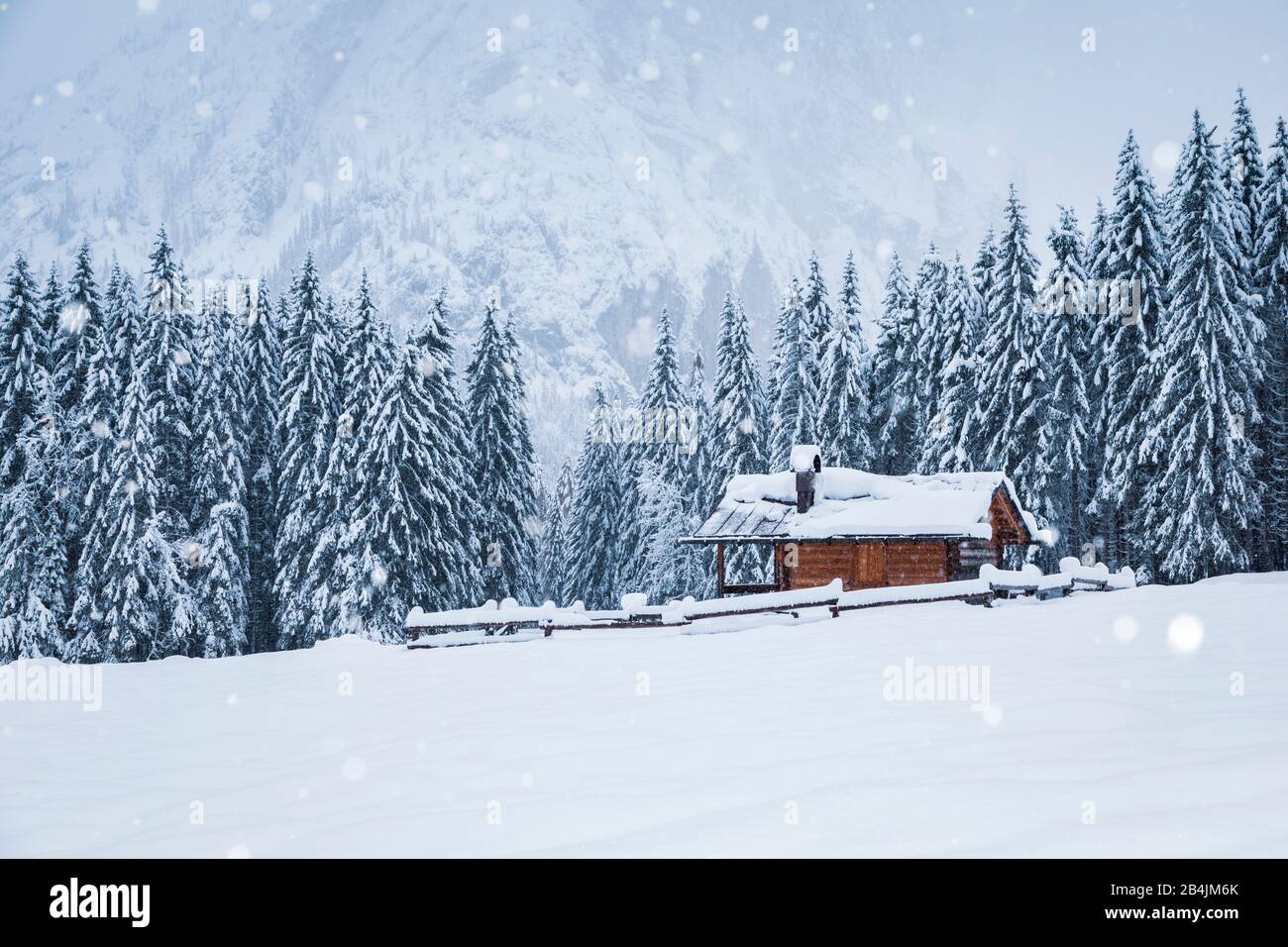 winter landscape with a wooden house in snowy mountains, Ansiei valley, Auronzo di Cadore, Belluno, Veneto, Italy Stock Photo