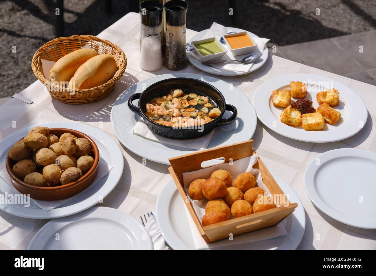 Tapas, croquettes, papas arrugadas, prawns in garlic, goat's cheese, Playa Quemada at Yaiza, Lanzarote, Canary Islands, Spain Stock Photo