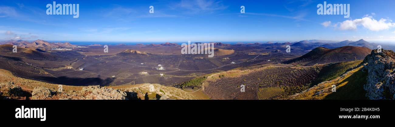 Panoramic view of Montana de Guardilama, wine region La Geria, left villages Uga and Yaiza, Lanzarote, Canary Islands, Spain Stock Photo