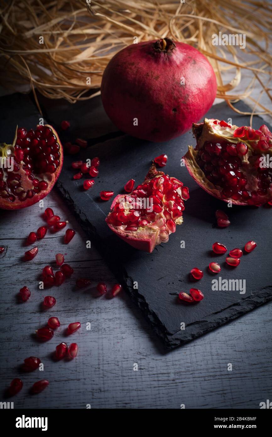 Pomegranate on slate plate Stock Photo