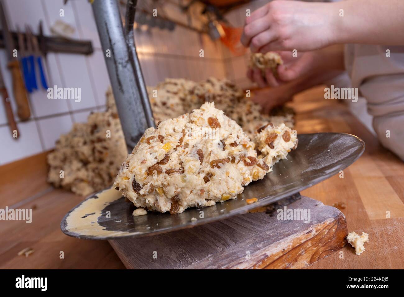 On an old scale is a dough ball with sultanas. It is needed for the preparation of Christmas stollen. Stock Photo