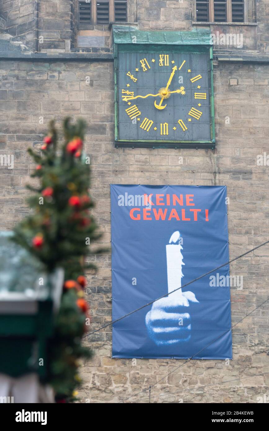 Germany, Saxony-Anhalt, Halle, red tower, clock tower, transparent "No violence!", Christmas decorations. Stock Photo