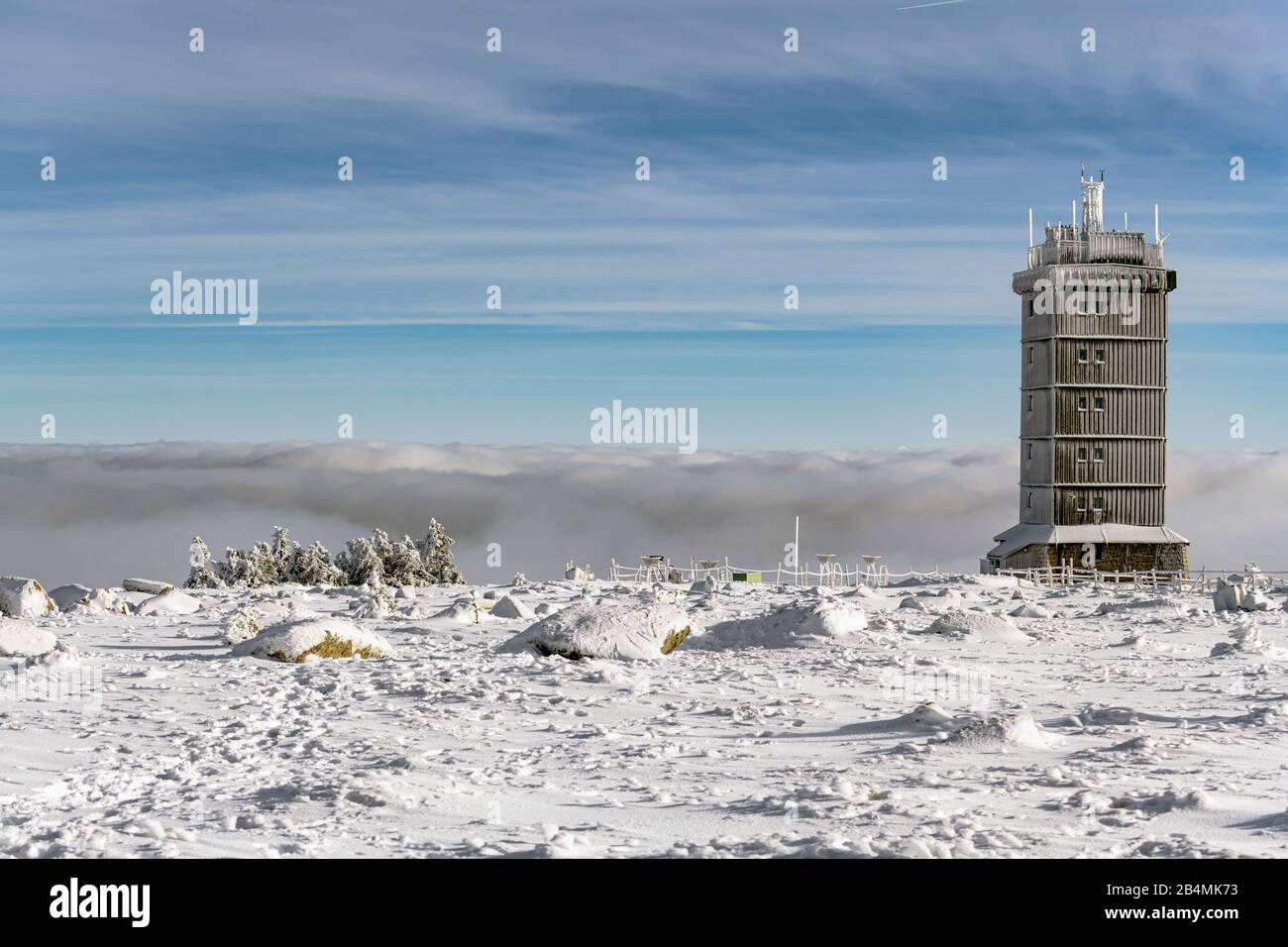 Snowcovered Brocken summit plateau with weather station, lowhanging