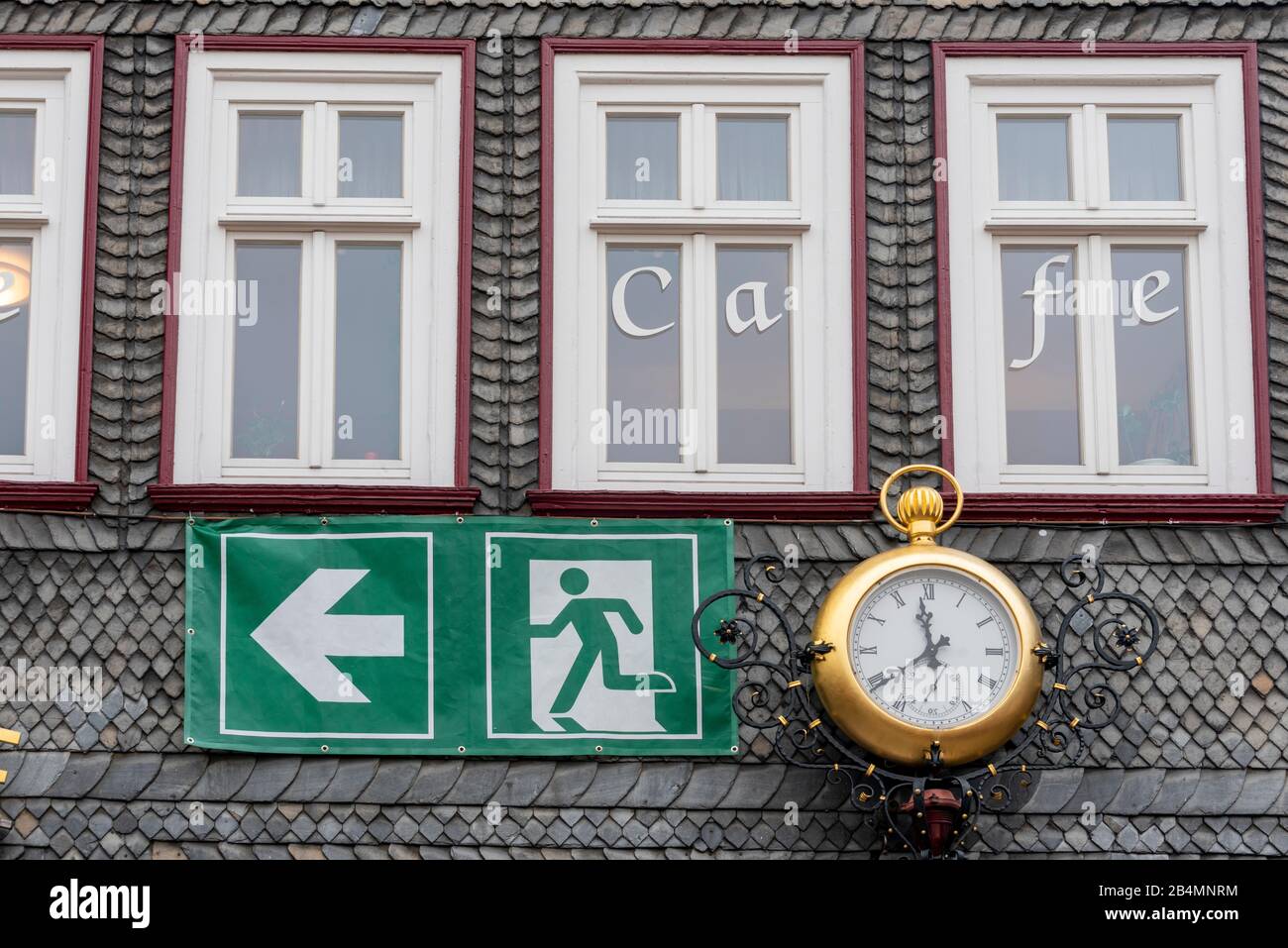 Germany, Lower Saxony, Harz, Goslar, escape route with clock, sign at a cafe. Stock Photo