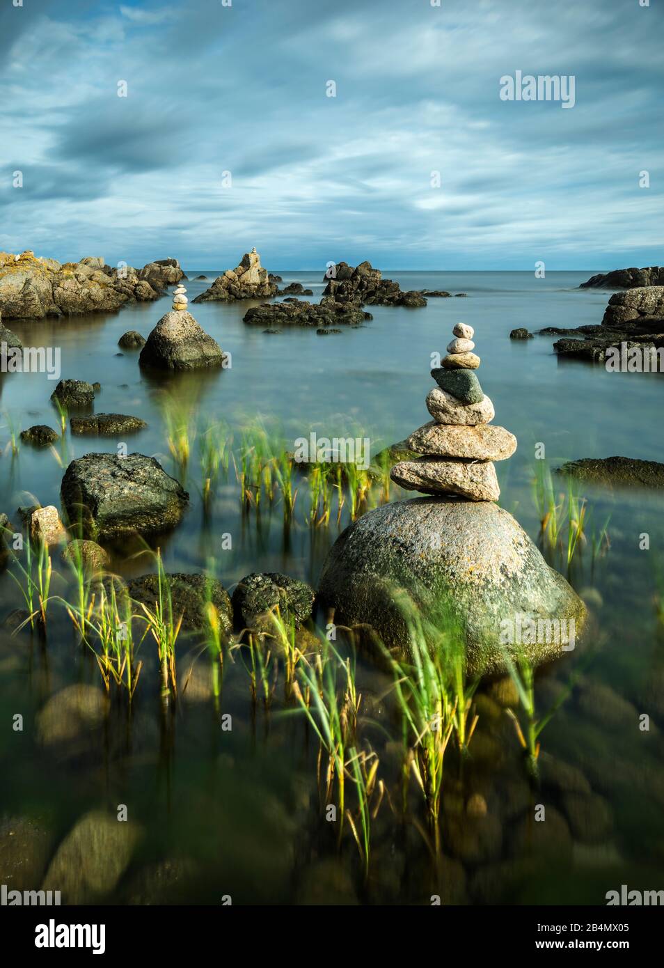 Denmark, Bornholm, Allinge-Sandvig, rocky coast with cairns Stock Photo