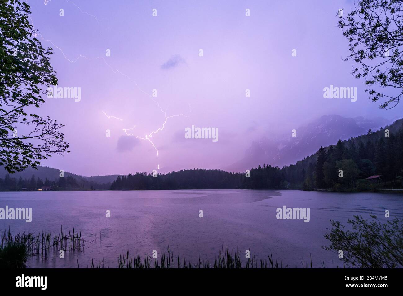 Thunderstorm and lightning strike in the Karwendel, seen at Lautersee near Mittenwald Stock Photo