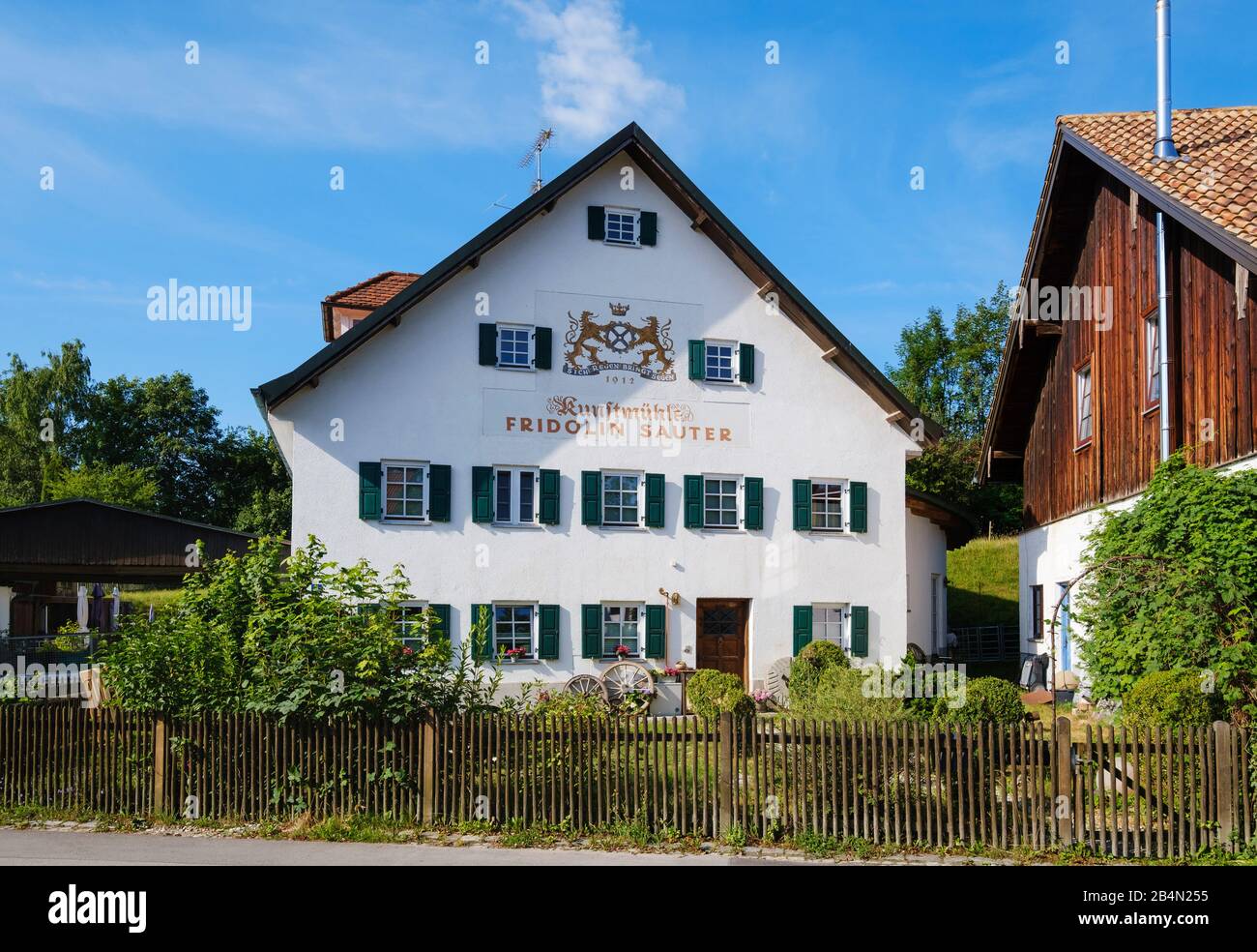 old apartment building with the inscription Kunstmühle Fridolin Sauter, Utting am Ammersee, Funfseenland, Upper Bavaria, Bavaria, Germany Stock Photo
