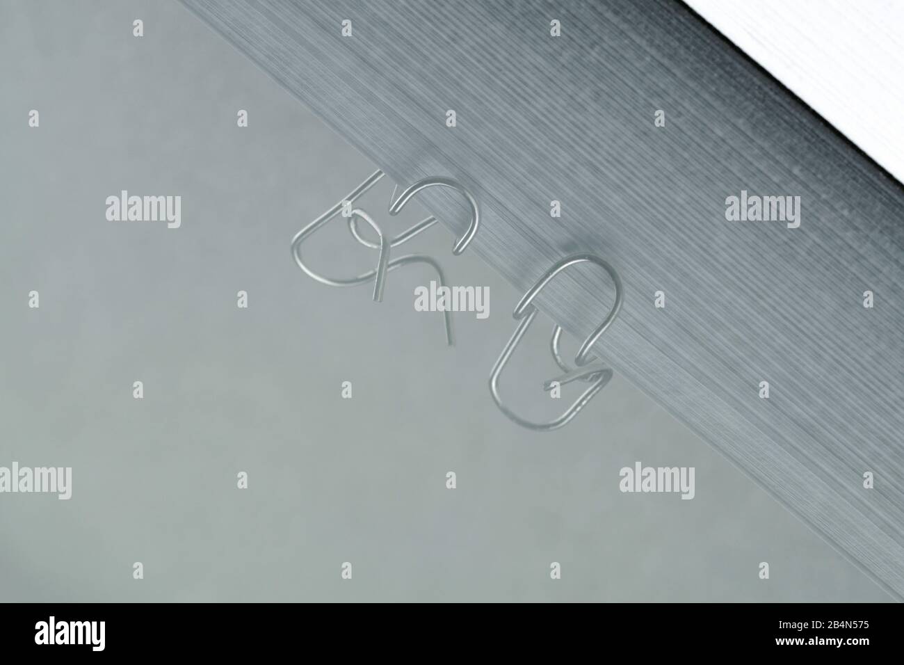 Paper clips are having a conversation, reflection Stock Photo