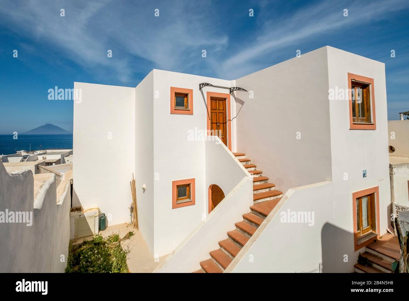 white house with staircase against a blue sky, brown stairs and door surround, Panarea, Aeolian Islands, Aeolian Islands, Tyrrhenian Sea, Southern Italy, Europe, Sicily, Italy Stock Photo