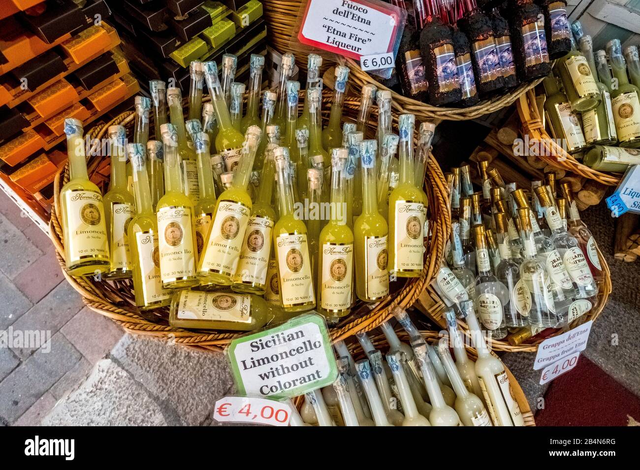 Alcoholic beverages and sales baskets in Taormina, southern Italy, Europe, Sicily, Italy Stock Photo