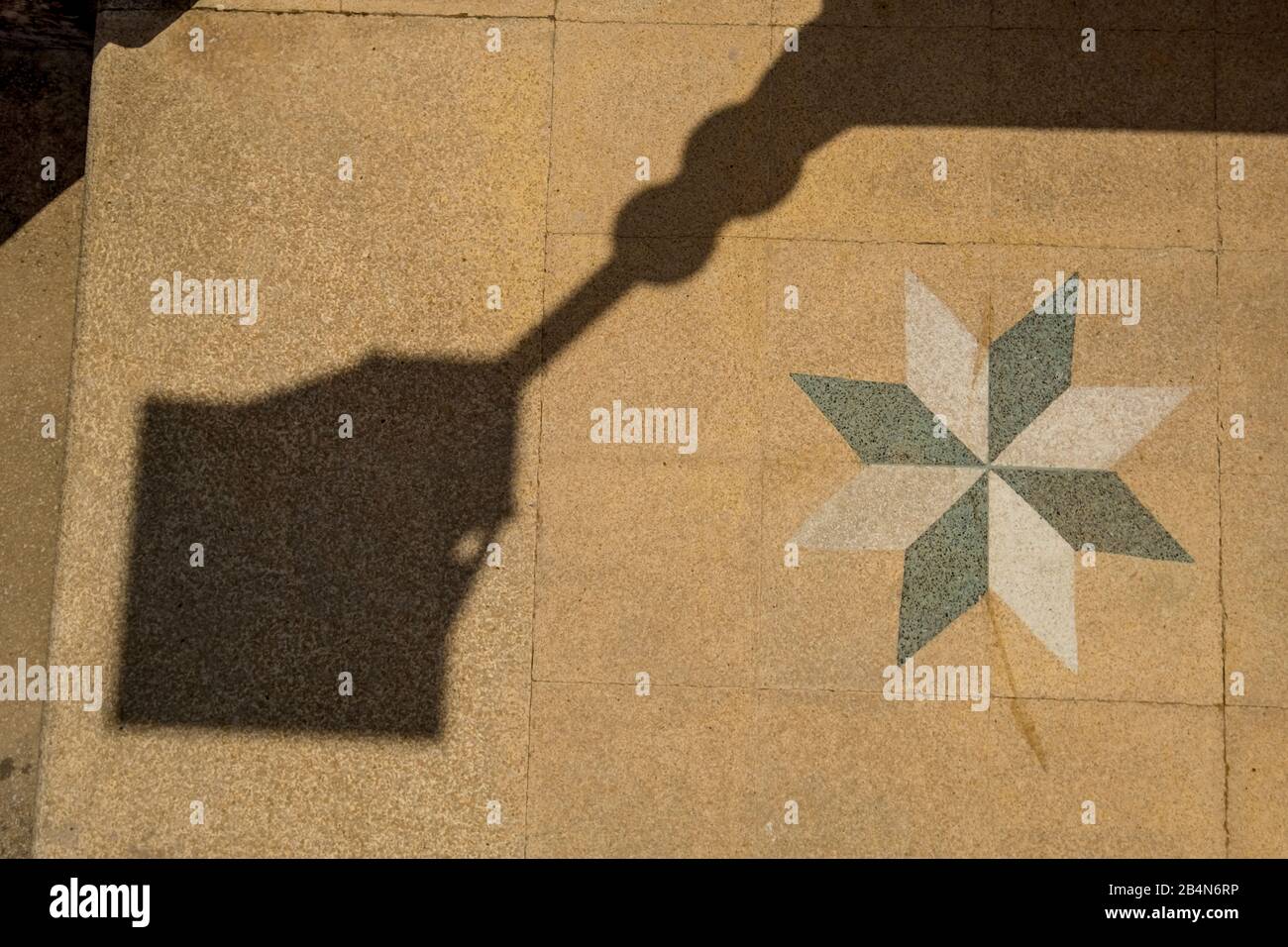 Shadows cast by a lantern on tiled floor with marquetry, San Giovanni la punta, southern Italy, Europe, Sicily, Italy Stock Photo