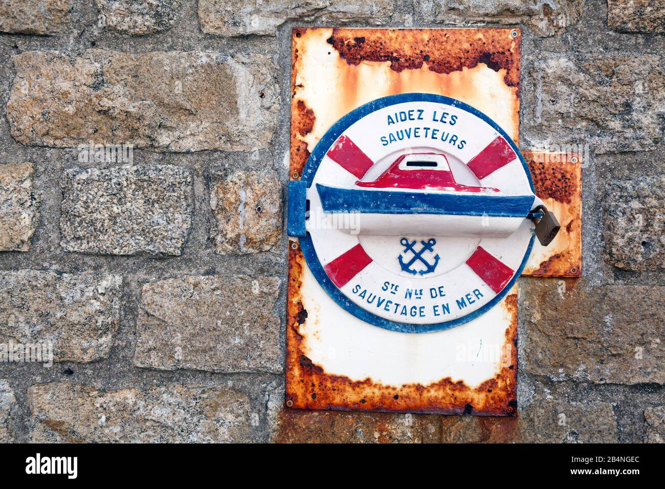 Donation safe on a light tower wall in Brittany. Help the rescue workers. Stock Photo