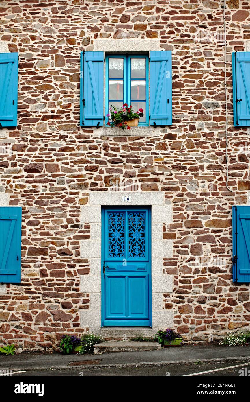 Stone house with blue windows and door with grille in Art Nouveau style. Pontrieux is a commune in the Brittany region in the Côtes-d'Armor department in the canton of Bégard. It lies on the banks of the Trieux river Stock Photo
