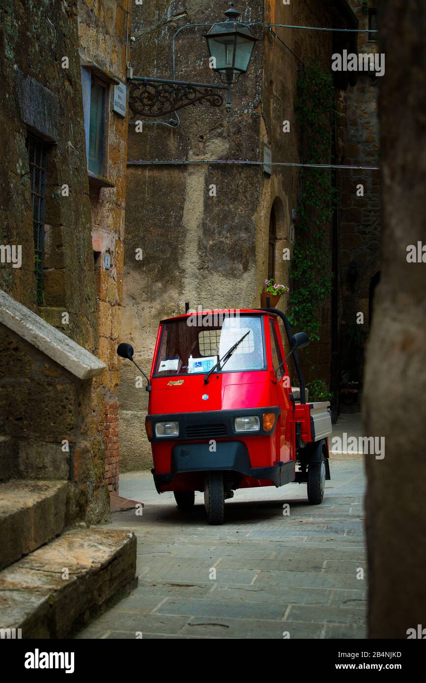 Pitigliano, Tuscany, Italy, small red car in an alley of the old town Stock Photo