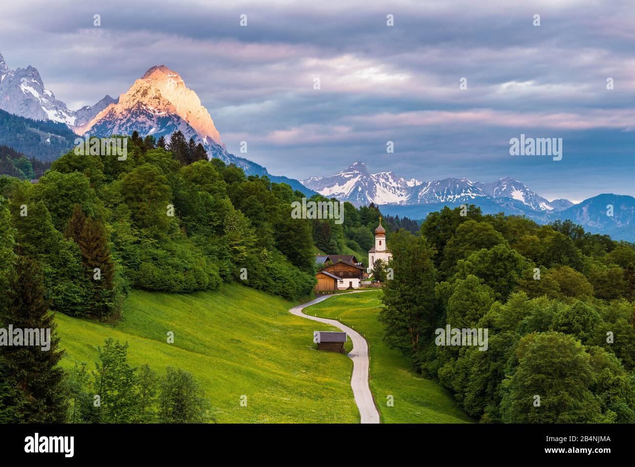 Wamberg with church and view of Wetterstein Mountains, Bavaria, Germany Stock Photo