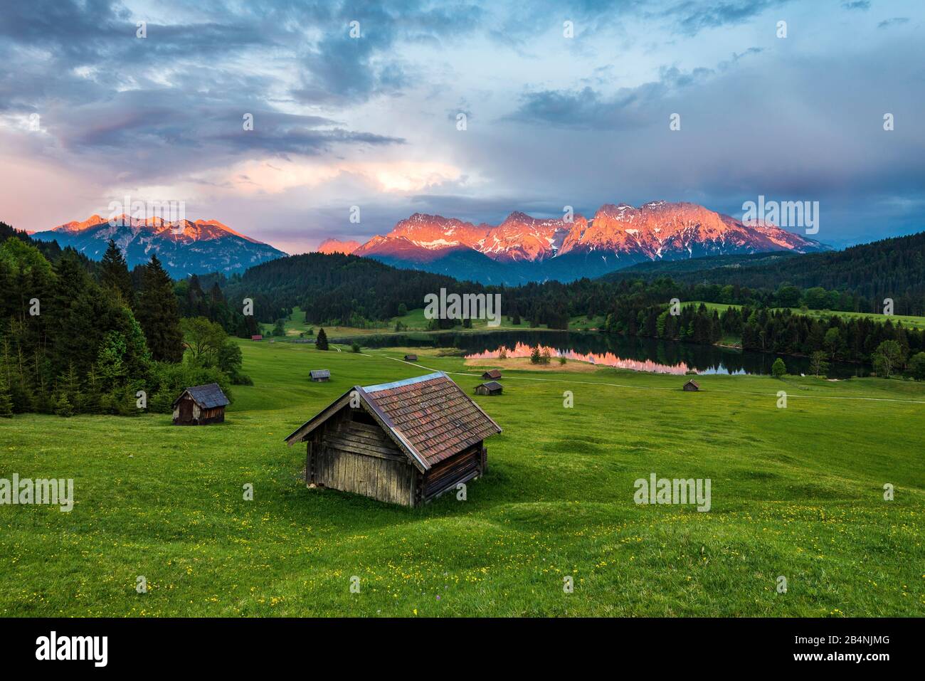 Geroldsee, huts on meadow, Karwendel, Bavaria, Germany, view of Karwendel mountains in the evening light Stock Photo