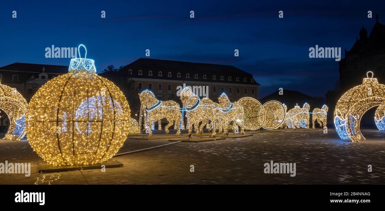 Deutschland, Sachsen-Anhalt, Magdeburg, auf dem Domplatz stehen beleuchtete Weihnachtskugeln und Pferde, die den berühmten Magdeburger Halbkugelversuc Stock Photo
