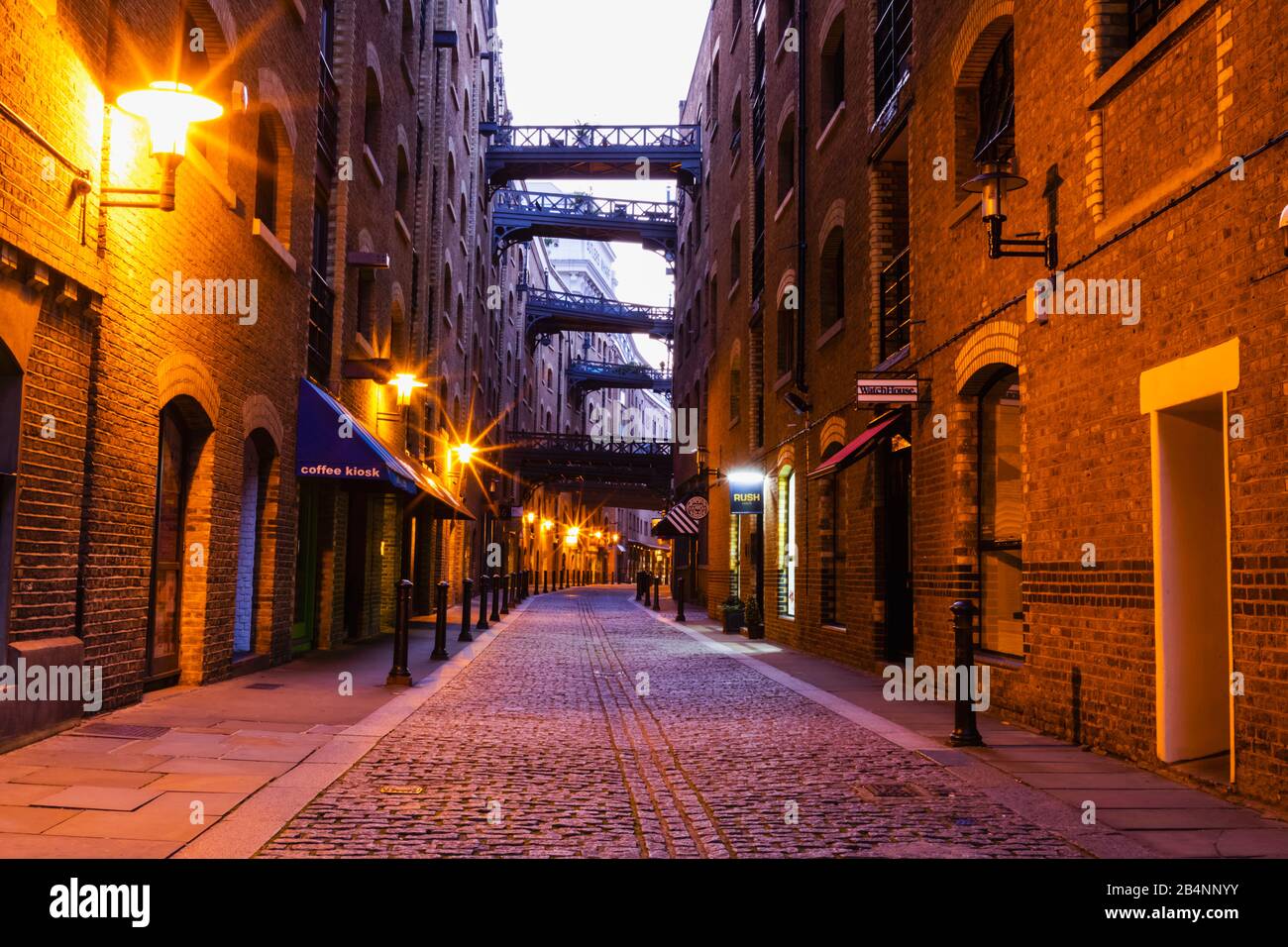 England, London, Southwark, Butlers Wharf, Shad Thames, Converted Victorian Warehouses and Cobblestone Street Stock Photo